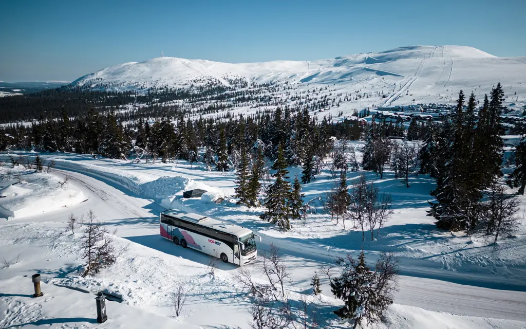 Winter dressed person outside a NOR-WAY bus