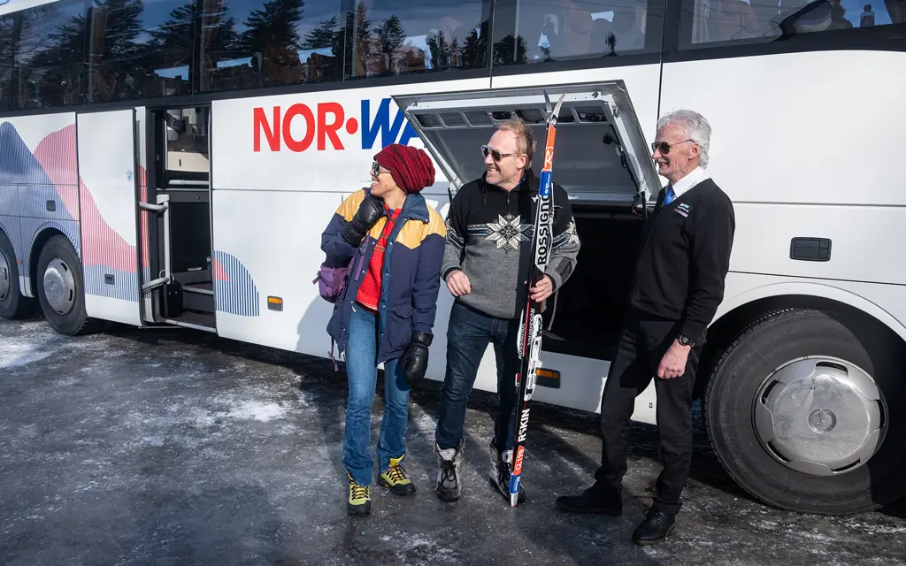 Jente på vei til buss med ski